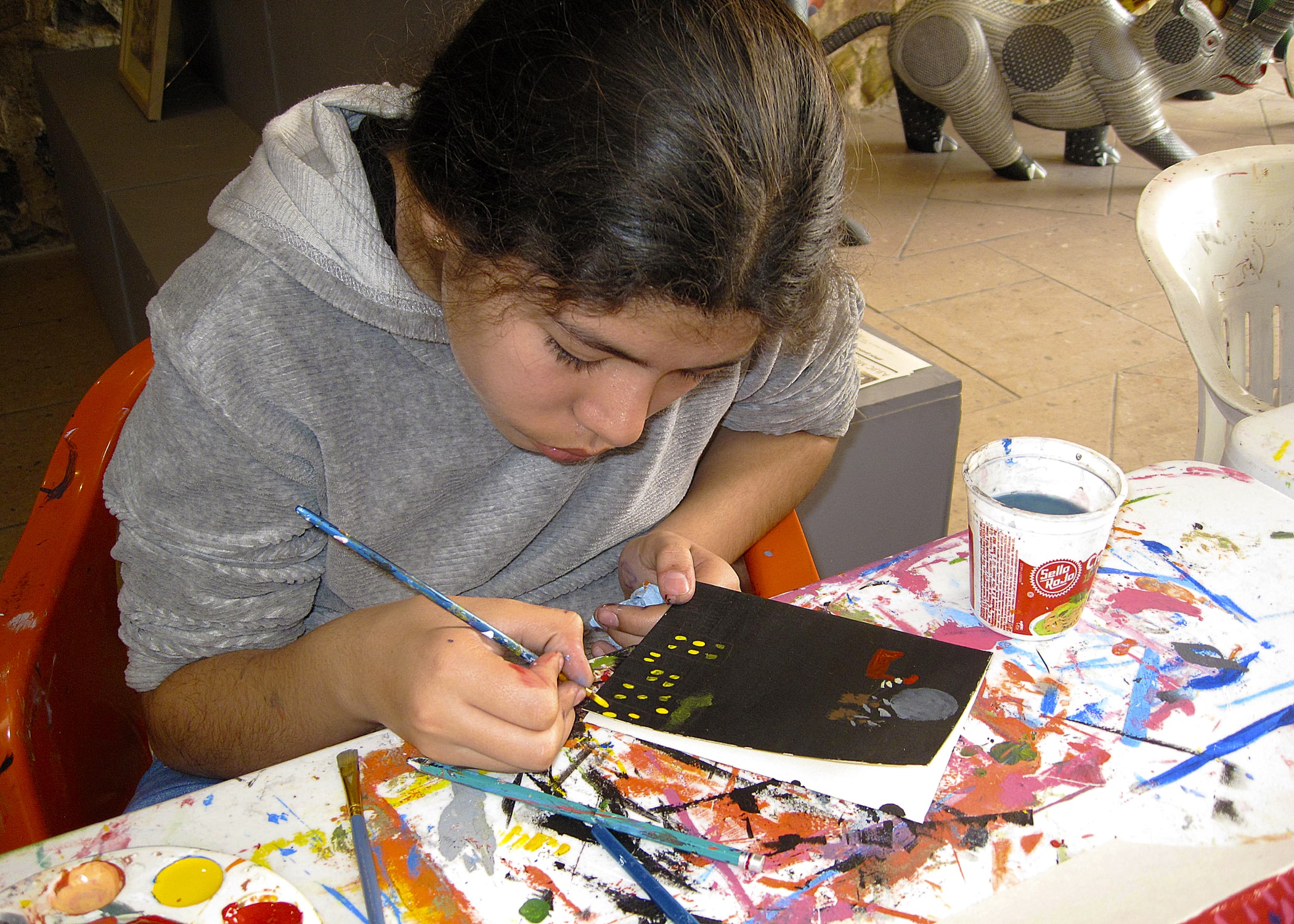 Young artist applying details to work